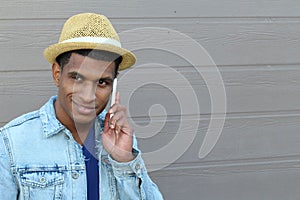 Outdoor portrait of modern young man with mobile phone with copy space on the right side