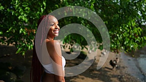 Outdoor portrait of natural Beautiful young African American woman long red braids hair style and perfect white teeth