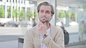 Outdoor Portrait of Pensive Young Man Thinking