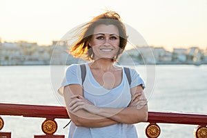 Outdoor portrait of positive smiling middle-aged woman