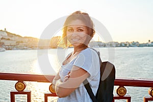 Outdoor portrait of positive smiling middle-aged woman