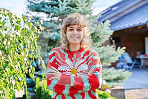 Outdoor portrait of positive teenage female looking at camera