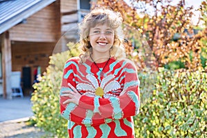 Outdoor portrait of positive teenage female looking at camera