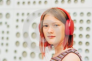 Outdoor portrait of pretty teenage girl with red dyed hair