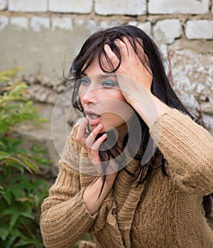 Outdoor portrait of a sad woman looking desperate