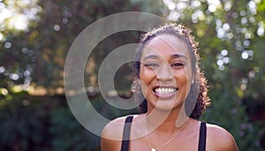 Outdoor Portrait Of Smiling African American Woman At Home  Relaxing At Garden Party