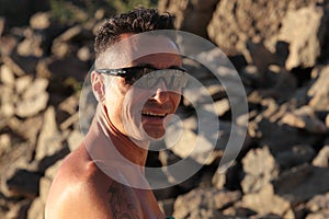 Outdoor portrait of smiling man with Oakley sunglasses photo