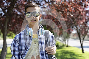 Outdoor portrait of smiling teenage boy caucasian student. Back to school. Secondary education