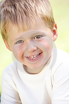 Outdoor Portrait Of Smiling Young Boy