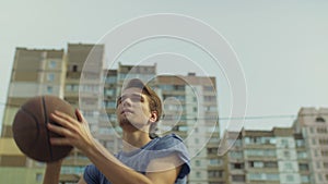 Outdoor portrait of streetball player taking shot