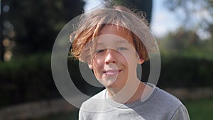 Outdoor portrait of a teenage boy in sunlight