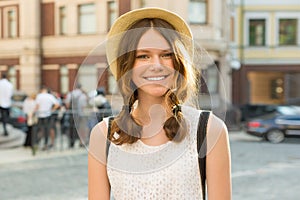 Outdoor portrait of teenage girl 13, 14 years old, city street background