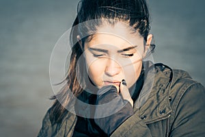 Outdoor portrait of a thoughtful teenage girl