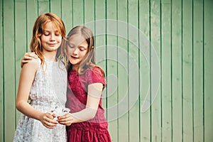 Outdoor portrait of two adorable little girls