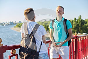 Outdoor portrait of two friends teenagers boys 15, 16 years old, laughing, talking