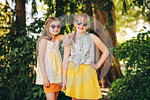 Outdoor portrait of two funny preteen girls