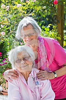 Outdoor portrait of two senior female friends