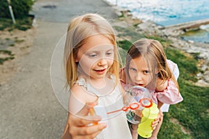 Outdoor portrait of two sweet little girls