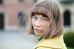 Outdoor portrait of woman turning back