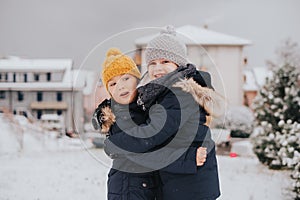 Outdoor portrait of young 6 year old boys wearing warm jacket
