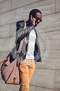 Outdoor portrait of young african man walking and talking