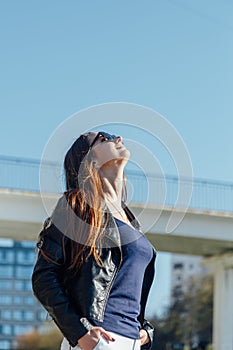 Outdoor portrait of a young beautiful confident woman posing on the street