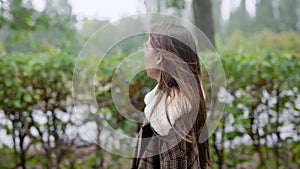 Outdoor portrait of young beautiful fashionable woman posing in street. Model wearing stylish brown coat. Female fashion