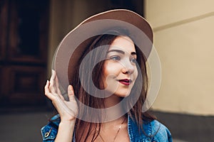 Outdoor portrait of young beautiful fashionable woman wearing stylish accessories. Street fashion