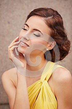 Outdoor portrait of young beautiful woman fashion model with closed eyes