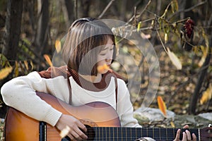 Asian girl playing the guitar.Country Western Musician