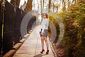 Outdoor portrait of young beautiful woman posing on street. in sunny day. Female fashion. City lifestyle