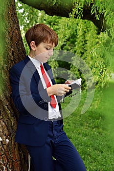 Outdoor portrait of boy going to First Holy Communion