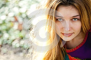 Outdoor portrait of young cute woman