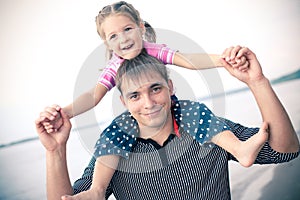 Outdoor portrait of young father with a daughter