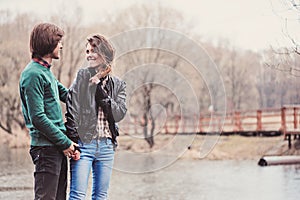 outdoor portrait of young happy loving couple walking in early spring