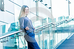 outdoor portrait of young happy smiling teen girl on a glass bridge on natural background