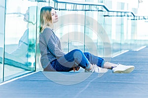 outdoor portrait of young happy smiling teen girl on a glass bridge on natural background