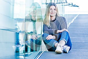 outdoor portrait of young happy smiling teen girl on a glass bridge on natural background