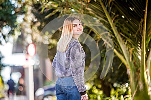 outdoor portrait of young happy smiling teen girl on natural background on a sunny day