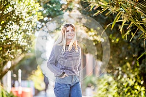 outdoor portrait of young happy smiling teen girl on natural background on a sunny day