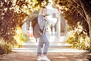 outdoor portrait of young happy smiling teen girl on natural background on a sunny day