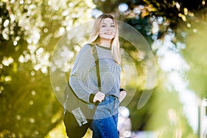 outdoor portrait of young happy smiling teen girl on natural background on a sunny day