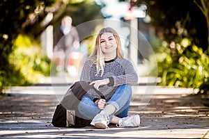 outdoor portrait of young happy smiling teen girl on natural background on a sunny day