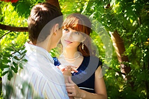 Outdoor portrait of young sensual couple. Love and kiss. Summer