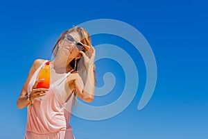 Outdoor portrait of young smiling beautiful woman enjoying sunny