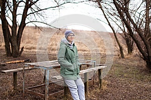 Outdoor portrait of young smiling  woman, wearing basics. Nature concept