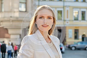 Outdoor portrait of young successful smiling business woman