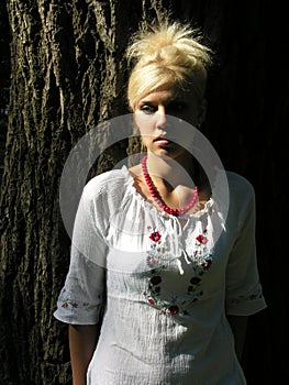 outdoor portrait of young ukrainian woman in traditional ukrainian clothes