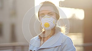 Outdoor portrait of a young woman in a protective mask. Epidemic of coronovirus covid-19. Walking around the city during