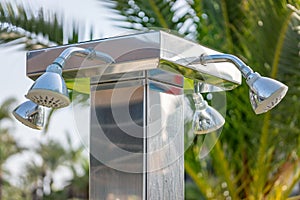 Outdoor refreshing shower heads  for spraying water to take shower before swimming in the pool or the sea in a hotel